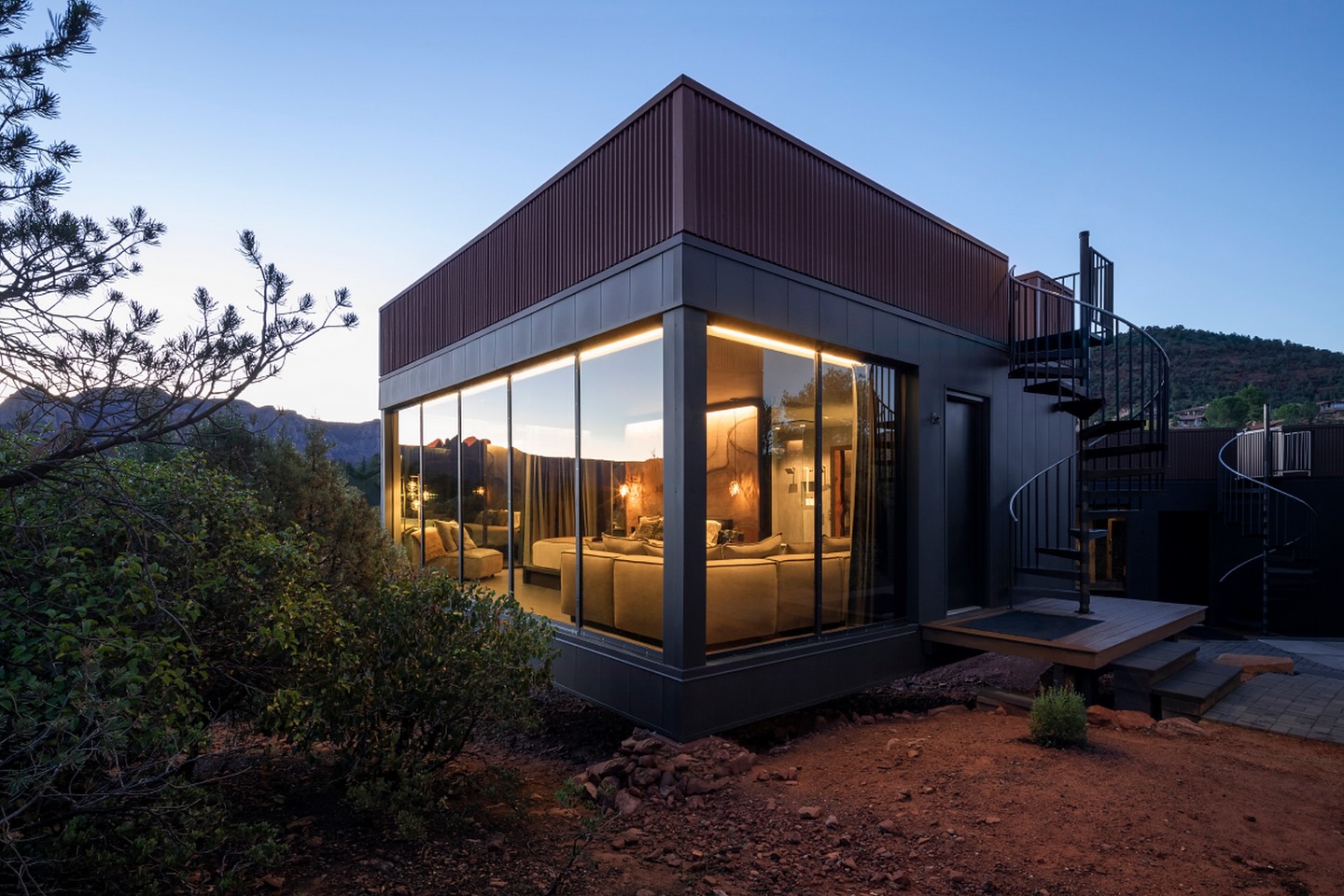 An elegant glass-walled suite at Ambiente: A Landscape Hotel in Sedona, blending modern architecture with the dramatic red rock surroundings. Experience immersive luxury in the heart of nature. Blog post by Sage Outdoor Advisory, offering Glamping and RV Feasibility Studies