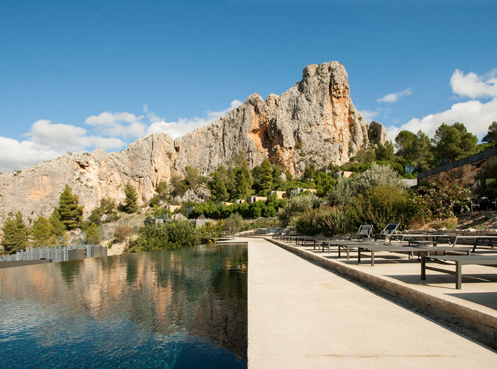 Vivood Landscape Hotel in Spain offers an unforgettable escape with its stunning infinity pool overlooking the rugged cliffs of the Guadalest Valley. Surrounded by lush greenery and modern architecture, this eco-luxury retreat seamlessly blends nature and relaxation.